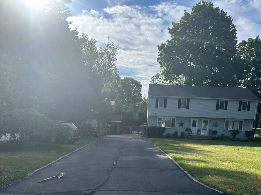 Driveway with crack sealing completed before sealcoat application