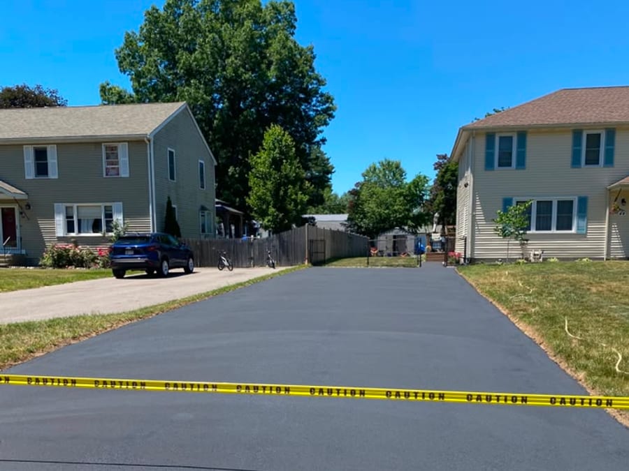 Finished neighborhood driveway with caution tape