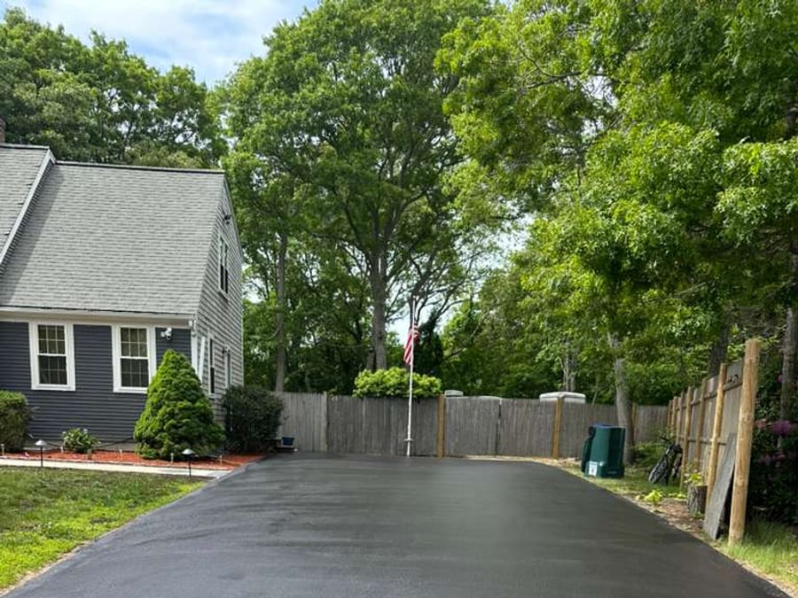 Side yard driveway finished with dark sealcoating