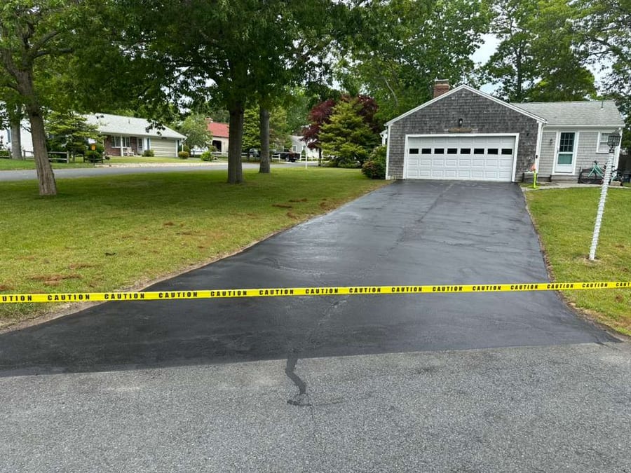 Finished sealcoated driveway protected with caution tape